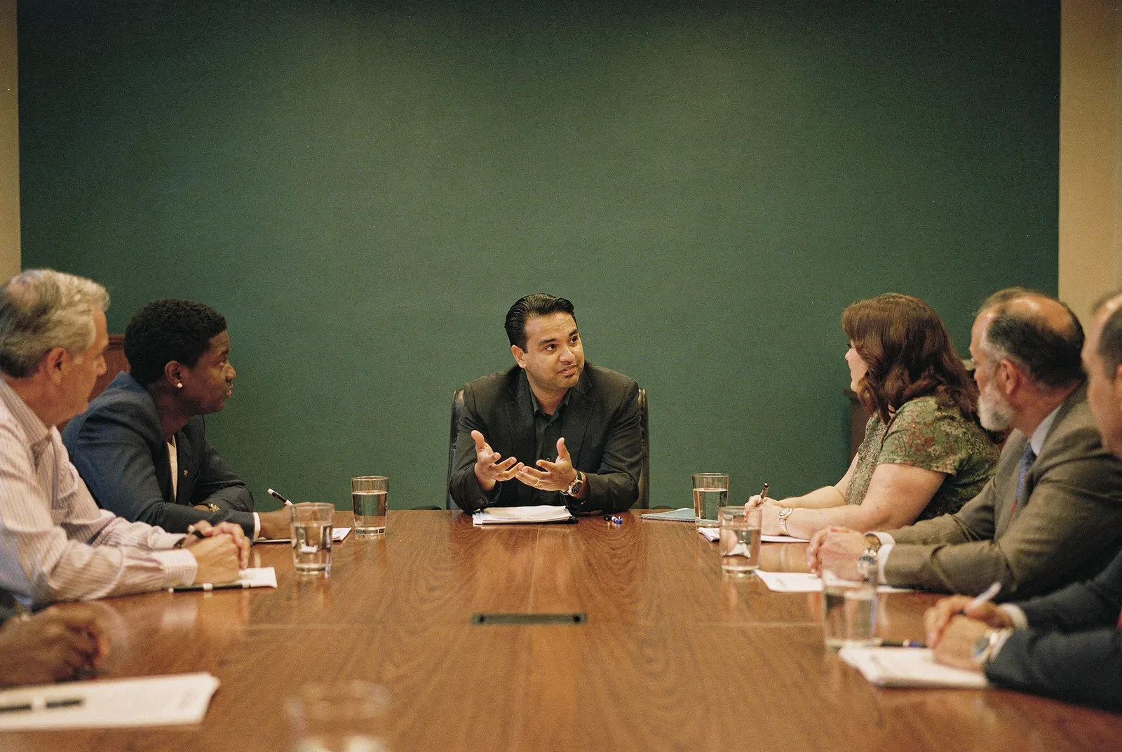 Members of the Riverbend Board of Education in discussion around the meeting table